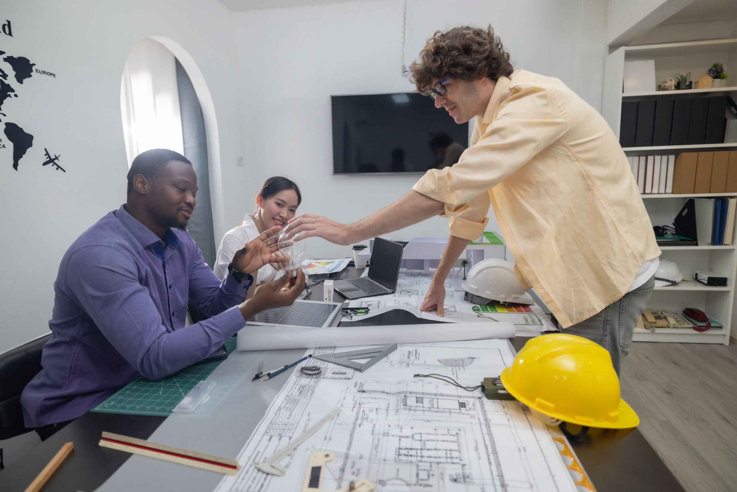 Team of architects planning sustainable, low CO2 emission buildings with innovative green technology to improve energy efficiency.