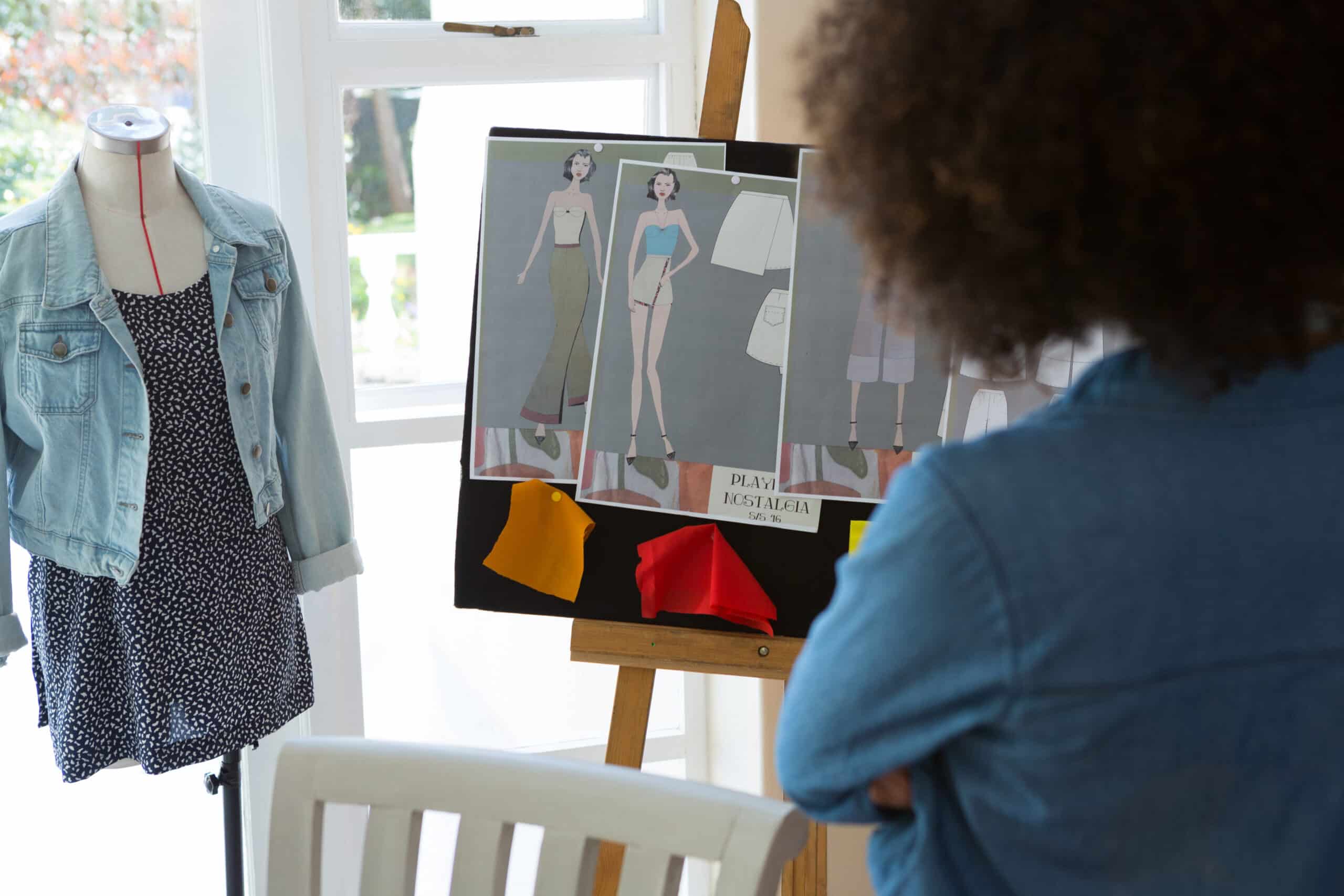 Female fashion standing near bulletin board at home